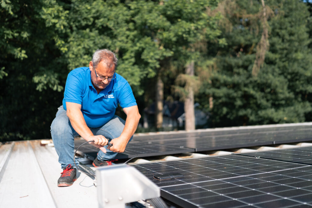 PV Anlage auf dem Dach mit einem Mitarbeiter